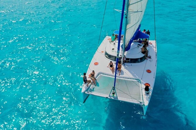 Isla Mujeres: Catamaran Tour with Snorkeling Food, Drinks, Beach - Spinnaker flight, crowds, and weather reality