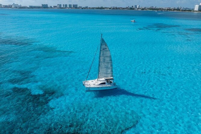 Isla Mujeres Day Tour with Catamaran, Snorkeling & Beach Club - Snorkeling at Bahia Mujeres: reef time, safety rules, and rough-water reality